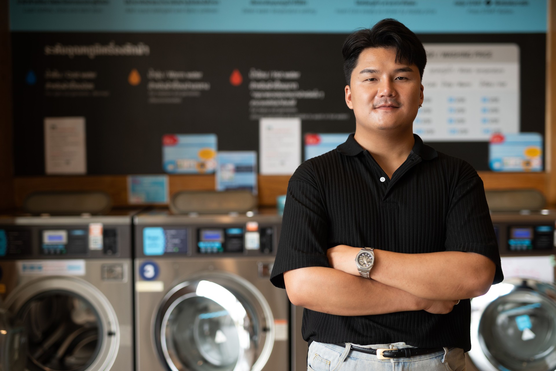 Young Asian man in laundry shop