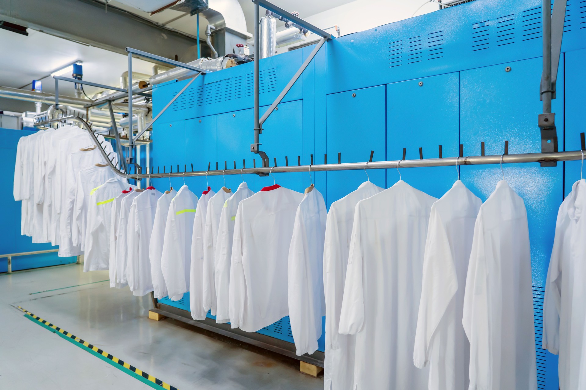 Washed clothes are being conveyed to ironing machine
